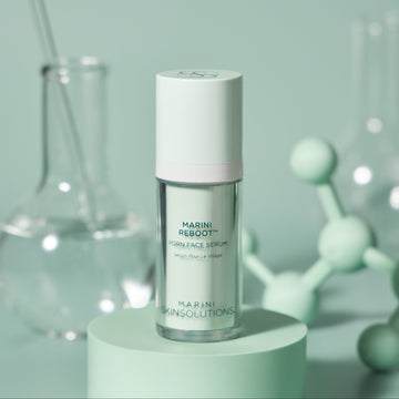 Skincare serum bottle on a green pedestal with a light green background